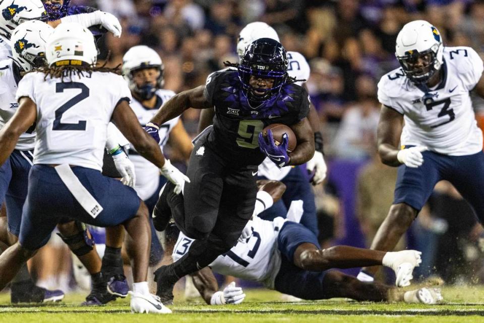 TCU running back Emani Bailey (9) evades West Virginia defenders in the first quarter of a Big XII conference game between the TCU Horned Frogs and the West Virginia Mountaineers at Amon G. Carter Stadium in Fort Worth on Saturday, Sept. 30, 2023. Chris Torres/ctorres@star-telegram.com