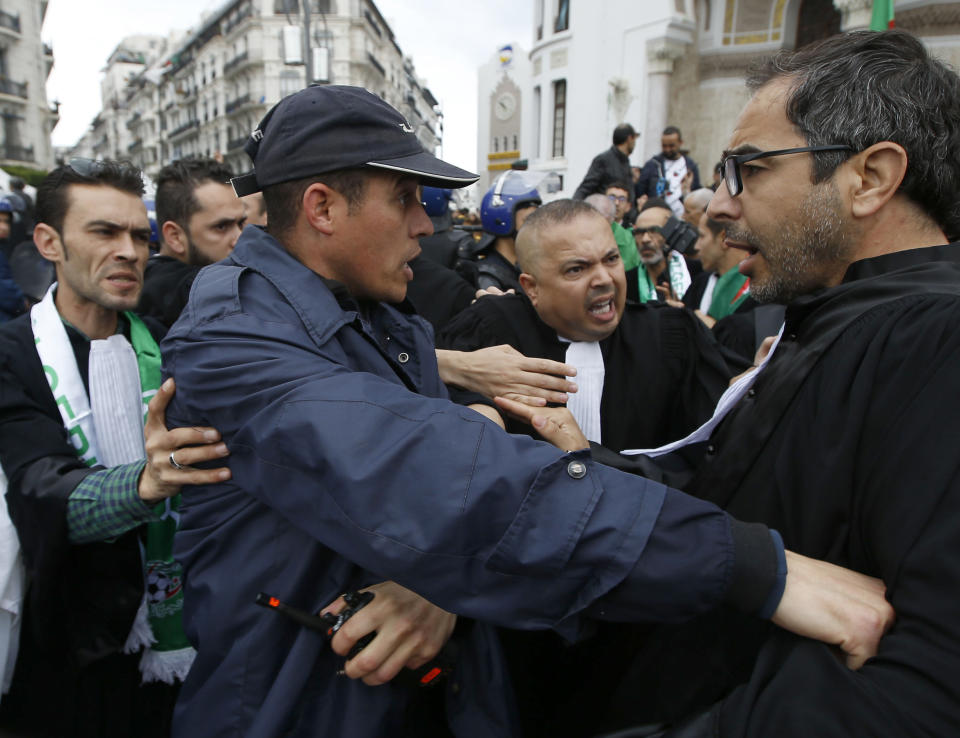 Algerian lawyers face riot police as they march to demand the departure of ailing 82-year-old Algerian President Abdelaziz Bouteflika at the end of his term scheduled on April 28, in Algiers, Saturday, March 23, 2019. The march comes a day after thousands of people demonstrated for the fifth straight Friday since nationwide anti-Bouteflika protests began on Feb. 22.(AP Photo/Anis Belghoul)