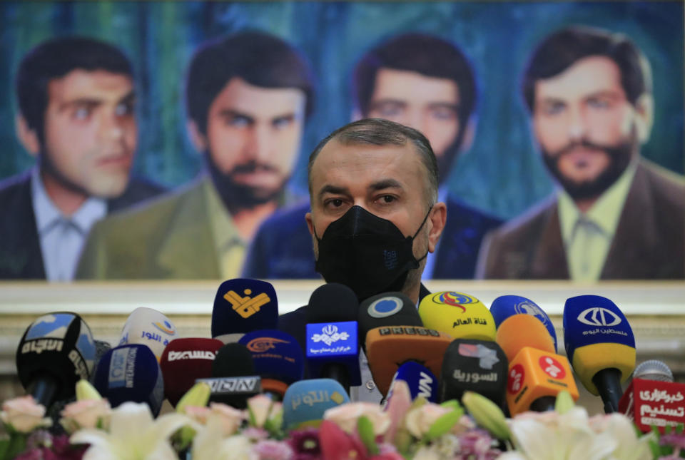 Iranian Foreign Minister Hossein Amirabdollahian, speaks during a press conference in front of a painting of four missing Iranian diplomats who disappeared during the 1982 Israeli invasion of Lebanon, at the Iranian embassy, in Beirut, Lebanon, Friday, Oct. 8, 2021. Amirabdollahian said Friday that there is a need for more talks with Saudi Arabia, his country's regional archrival, adding that the negotiations so far have been heading in the right direction. (AP Photo/Hussein Malla)