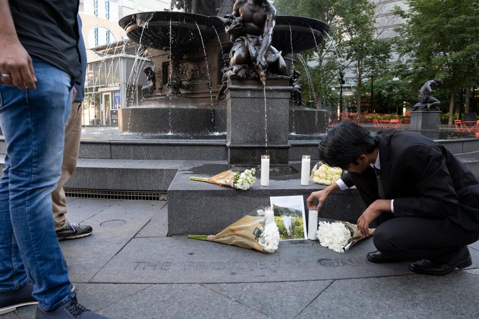Srivenkat Poolla lights a candle as friends of Prudhvi Kandepi gather on Fountain Square on Friday, September 6, 2019 in downtown Cincinnati, Ohio on the anniversary of his death. Kandepi was fatally shot along with two others before police killed the gunman.