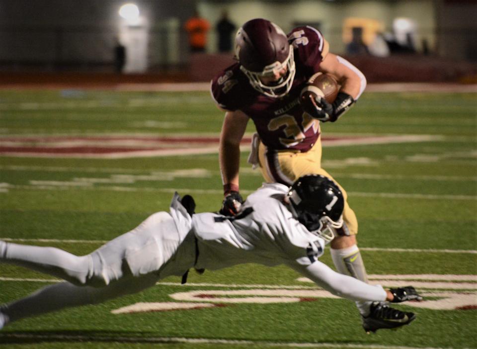 Killingly junior Soren Rief tries to avoid Wethersfield's Ben Caulfield during Killingly's 34-13 win Tuesday at Morgan Field.