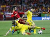 Spain's Isco (top L) fight for the ball with Ukraine's Olexandr Kucher (bottom L) and Taras Stepanenko during their Euro 2016 qualifier soccer match at Ramon Sanchez Pizjuan stadium in Seville, March 27, 2015. REUTERS/Marcelo del Pozo