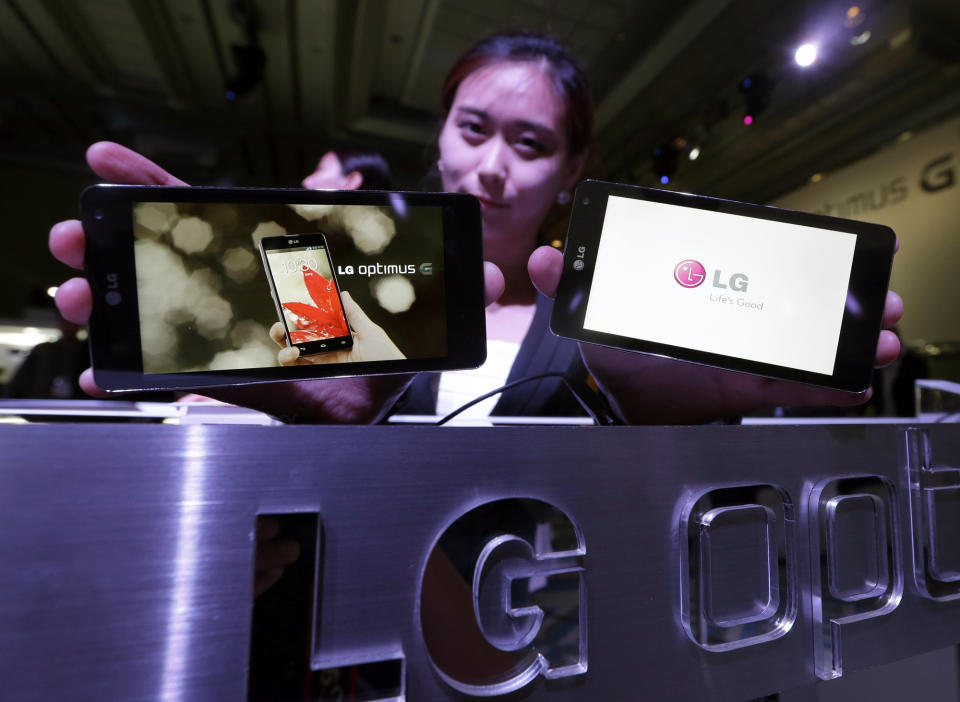 Models pose with LG Electronics' new smartphone the Optimus G during its unveiling ceremony in Seoul, South Korea, Tuesday, Sept. 18, 2012. LG Electronics will launch the Optimus G smartphone next week in South Korea, pinning hope on the new Android device to help revive its loss-making mobile business. (AP Photo/Lee Jin-man)