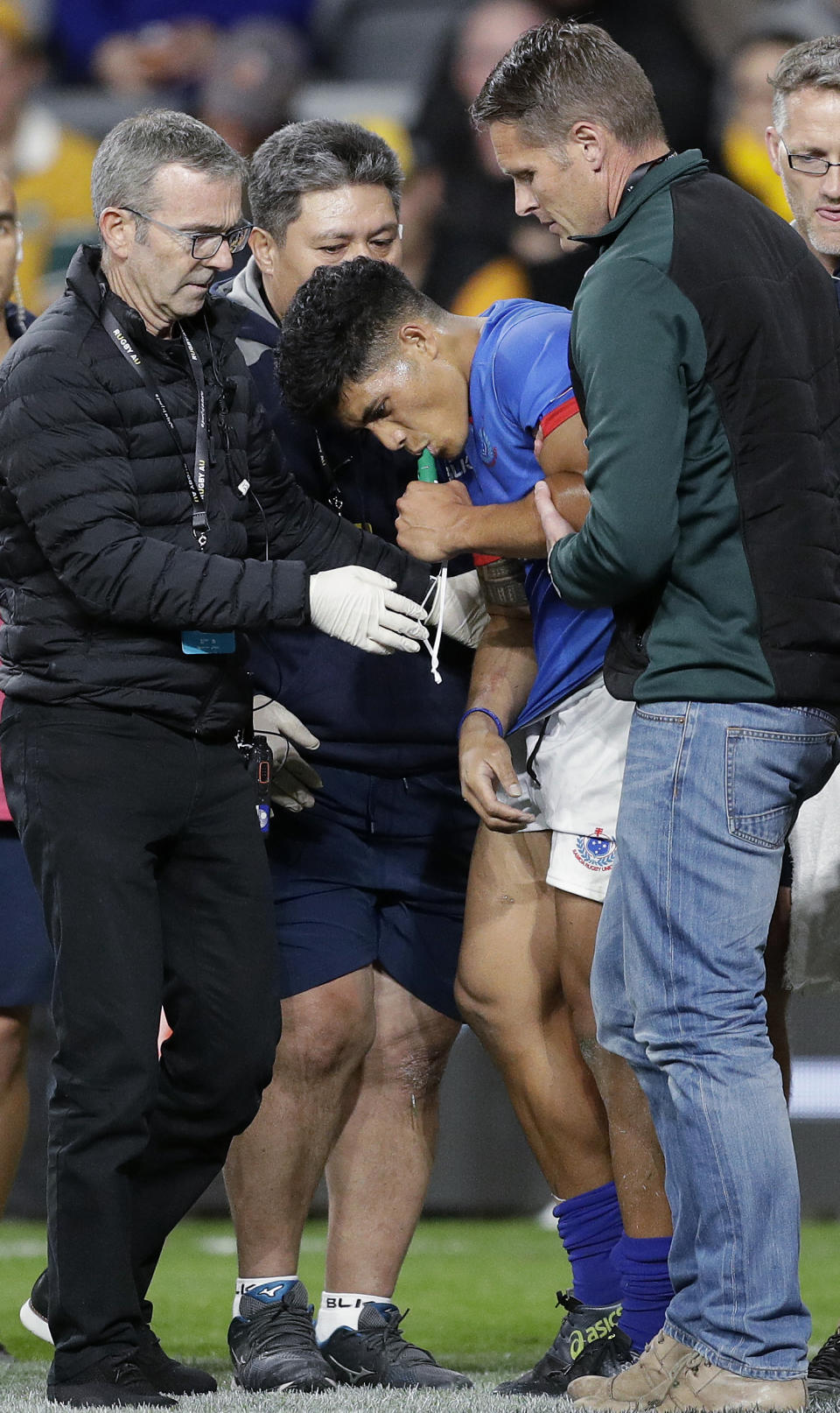 Samoa's Scott Malolua, center, is assisted off the field after an injury during their rugby union test match against Australia in Sydney, Saturday, Sept. 7, 2019. (AP Photo/Rick Rycroft)