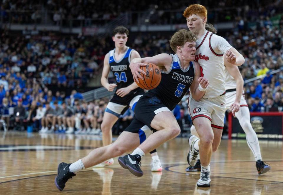 Timberline guard Bryce Elder drives into Oyhee’s Jackson Rogers in the 5A boys basketball state championship game March 2 at the Ford Idaho Center in Nampa. Elder helped lead Timberline to an academic state title.