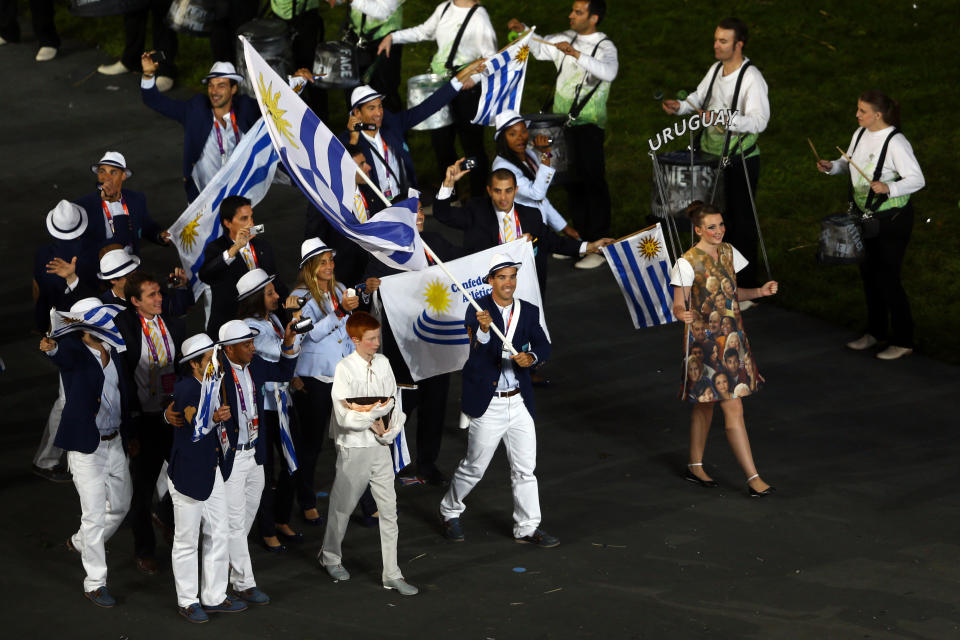 LONDON, ENGLAND - JULY 27: Rodolfo Collazo Tourn of the Uruguay Olympic rowing team carries his country's flag during the Opening Ceremony of the London 2012 Olympic Games at the Olympic Stadium on July 27, 2012 in London, England. (Photo by Paul Gilham/Getty Images)