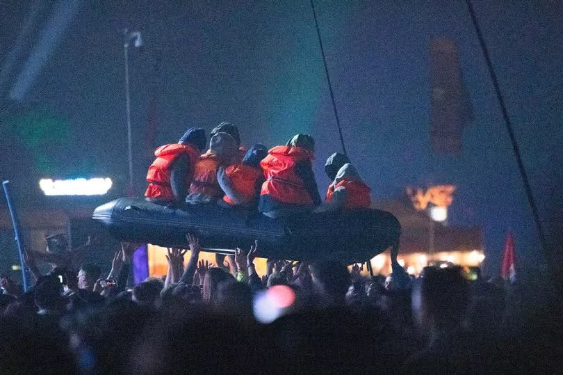 The inflatable life raft holding dummy migrants appeared during Idles' Friday night performance