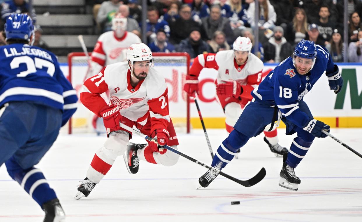 Red Wings forward Dylan Larkin skates with the puck as Maple Leafs forward Noah Gregor gives pursuit in the second period on Sunday, Jan. 14, 2024, in Toronto.