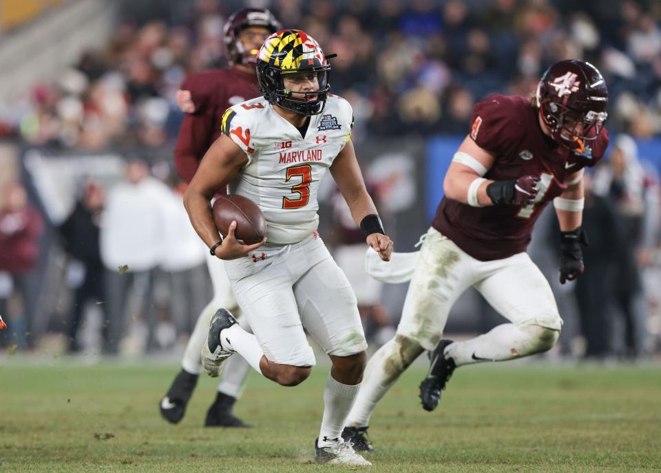 Maryland  quarterback Taulia Tagovailoa (3) runs the ball as Virginia Tech linebacker Dax Hollifield (4) pursues during the second half of the Pinstripe Bowl.