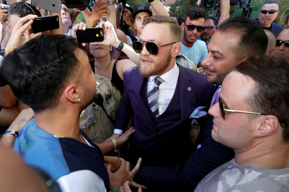 UFC lightweight champion Conor McGregor (C) of Ireland has words with former sparring partner Paulie Malignaggi (L) after his arrival at Toshiba Plaza in Las Vegas, Nevada U.S. on August 22, 2017. (Reuters)