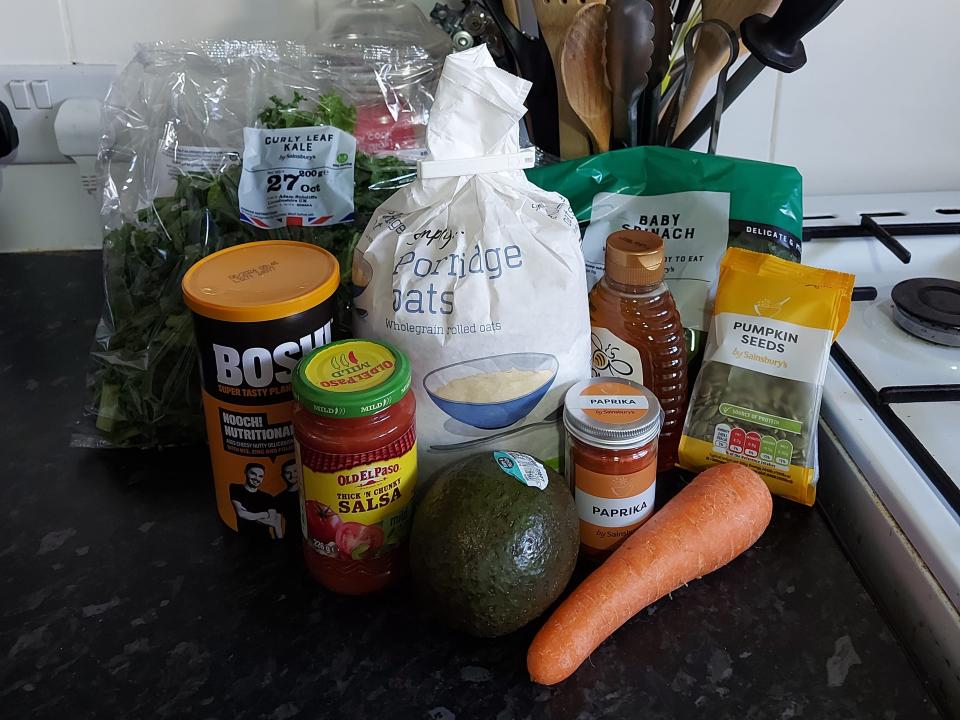 All the ingredients for Loma salsa, kale, and carrot savory oatmeal displayed in height order.