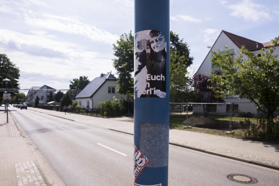 A destroyed sticker displayed on a lamp pole near the Mina Witkojc school with pictures of teachers Max Teske and Laura Nickel and the caption "piss off to Berlin" in Burg (Spreewald), Germany, Wednesday, July 19, 2023. Two teachers in eastern Germany tried to counter the far-right activities of students at their small town high school. Disheartened by what they say was a lack of support from fellow educators, Laura Nickel and Max Teske decided to leave Mina Witkojc School in Burg. (AP Photo/Markus Schreiber)