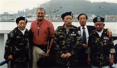 Merrill Edward Newman (2nd L) poses for group photo with former Kuwol Guerrilla Unit members at a port in Incheon, west of Seoul, in this undated photo provided on November 29, 2013 by Kim Chang-sun, who served his military duties as a Kuwol Guerrilla Unit member. REUTERS/Kim Chang-sun/Handout via Reuters