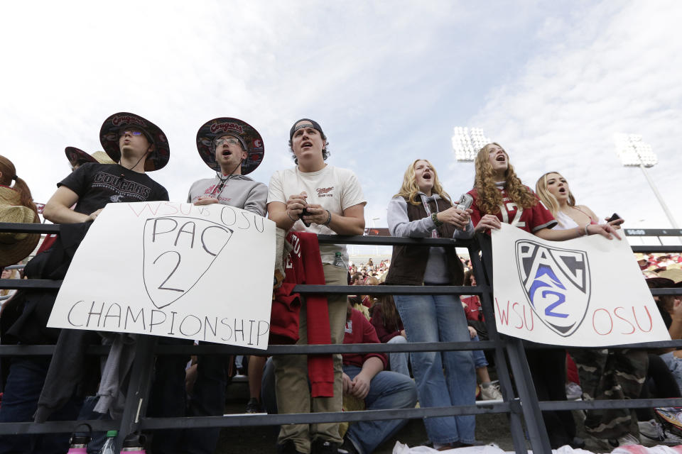 Washington State University students cheer with "Pac-2" signs as Washington State players enter the field during warmups before an NCAA college football game against Oregon State, Saturday, Sept. 23, 2023, in Pullman, Wash. The two schools are the only ones remaining in the Pac-12 after the 2023-2024 academic year after the other schools in the conference announced plans to leave. (AP Photo/Young Kwak)