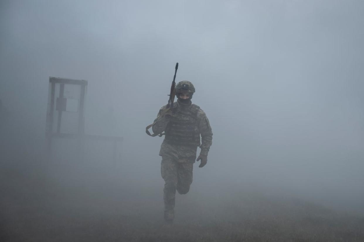 A new recruit of the 1st Da Vinci Wolves Separate Mechanized Battalion is seen taking part in a training exercise in central Ukraine last month. (Viacheslav Ratynskyi/Reuters - image credit)