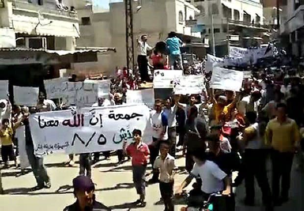 An image from a video on YouTube shows Syrian anti-government demonstrators marching in Idlib, northwestern Syria, on August 5. The US, French and German leaders pledged to consider new steps to punish Syria after security forces shot dead at least 22 people as tens of thousands staged anti-regime protests on the first Friday of Ramadan