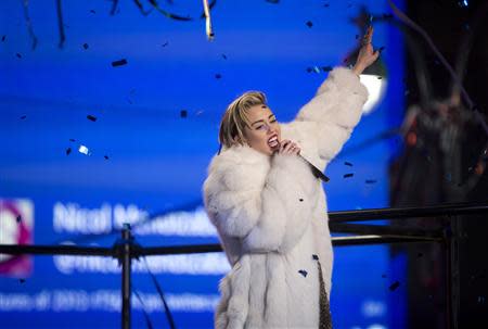 Singer Miley Cyrus performs during New Year's Eve celebrations at Times Square in New York, December 31, 2013. REUTERS/Carlo Allegri