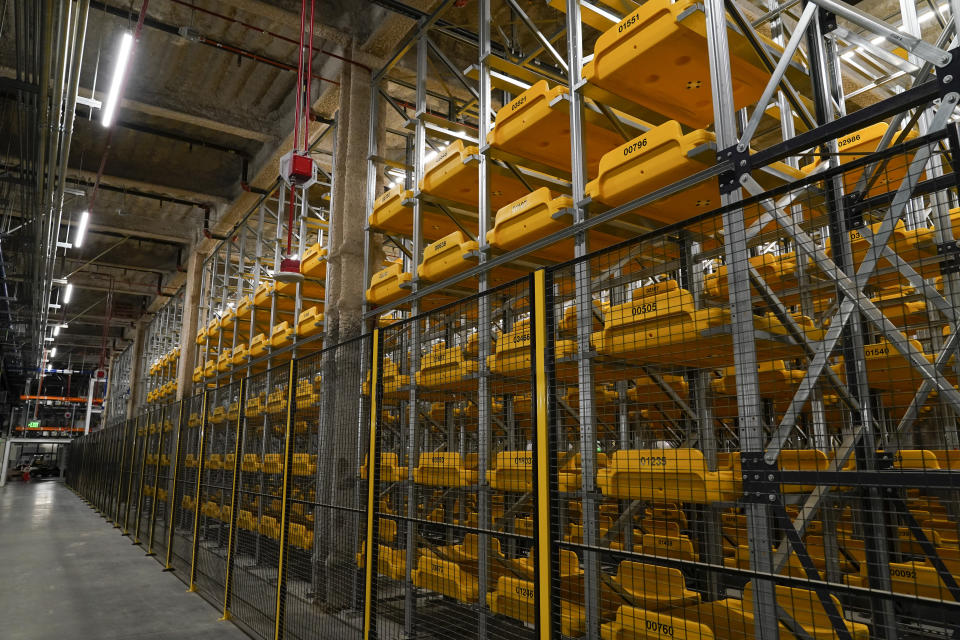 An automated storage and retrieval baggage handling system uses plastic trays with radio-frequency tags to track and store passengers' bags at the new West Gates at Tom Bradley International Terminal at Los Angeles International Airport Monday, May 24, 2021, in Los Angeles. The system will allow travelers to check in bags up to 24 hours in advance of their flight. (AP Photo/Ashley Landis)