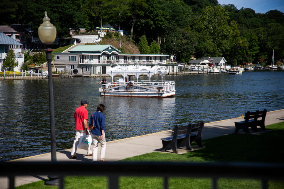 The Saugatuck Chain Ferry, the nation's lone surviving chain ferry, brings groups of people across the Kalamazoo River Friday, Aug. 12, 2022, in downtown Saugatuck. The boat pulls passengers across the river by a gearbox and chain that runs the length of the river.