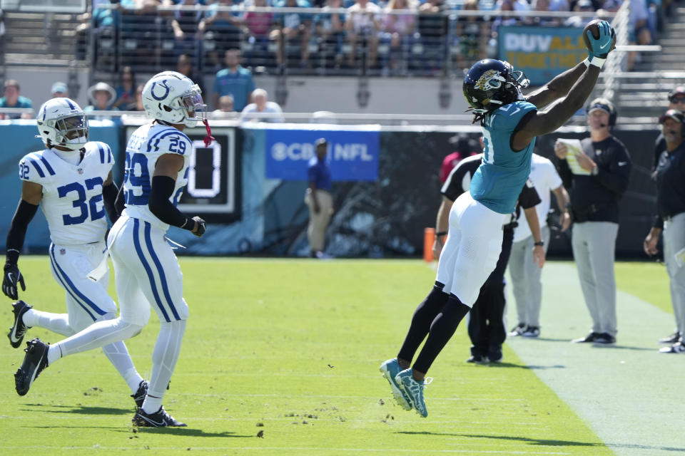 Jacksonville Jaguars wide receiver Calvin Ridley, right, tries to catch a pass against Indianapolis Colts cornerback JuJu Brents (29) and Julian Blackmon (32) during the first half of an NFL football game, Sunday, Oct. 15, 2023, in Jacksonville, Fla. The pass was incomplete. (AP Photo/John Raoux)