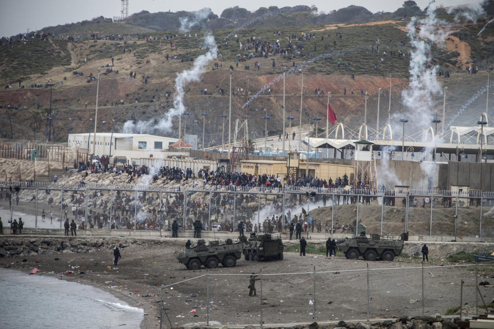 Spanish Army and Guardia Civil officers take positions next to the border of Morocco and Spain, at the Spanish enclave of Ceuta, on Tuesday, May 18, 2021. About 8,000 people have streamed into the Spanish city of Ceuta from Morocco in the past two days in an unprecedented influx of migrants, most of them swimming across the border to reach the Spanish enclave in North Africa. (AP Photo/Javier Fergo)