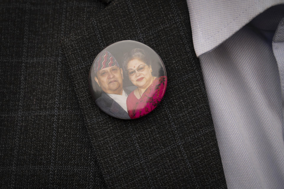 A supporter wears photographs of former king Gyanendra and former queen Komal Rajya Laxmi Shah on his coat during a pro-monarchy protest in Kathmandu, Nepal, Feb. 21, 2024. Nepal’s once unpopular monarchy — abolished after centuries of rule over the Himalayan nation — is hoping to regain some of its lost glory. Royalist groups and supporters of former King Gyanendra have been holding rallies to demand the restoration of the monarchy and the nation’s former status as a Hindu state. (AP Photo/Niranjan Shrestha)