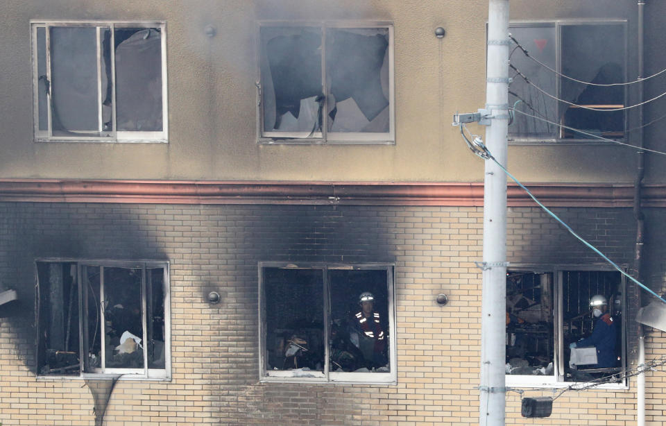 Firefighters inside an animation company building which was attacked (Photo credit should read JIJI PRESS/AFP/Getty Images)