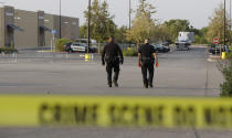 <p>San Antonio police officers investigate the scene where eight people were found dead in a tractor-trailer loaded with at least 30 others outside a Walmart store in stifling summer heat in what police are calling a horrific human trafficking case, Sunday, July 23, 2017, in San Antonio. (AP Photo/Eric Gay) </p>