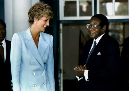 FILE PHOTO: The Princess of Wales talks to Zimbabwean President Robert Mugabe in Harare