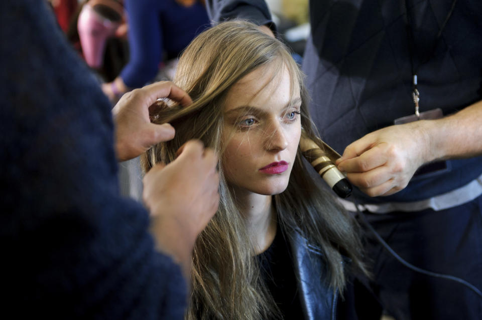 A model is prepared ahead of the Paul Smith collection during London Fashion Week, Sunday, Feb. 17, 2013, London. (Photo by Jonathan Short/Invision/AP)