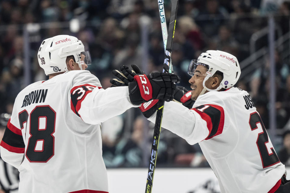 Ottawa Senators forward Patrick Brown, left, is congratulated by forward Mathieu Joseph after scoring a goal against the Seattle Kraken during the first period of an NHL hockey game Thursday, March 9, 2023, in Seattle. (AP Photo/Stephen Brashear)