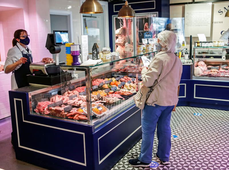 A lady shops inside Smith and Clay, a butchery and deli in Buckingham, Britain