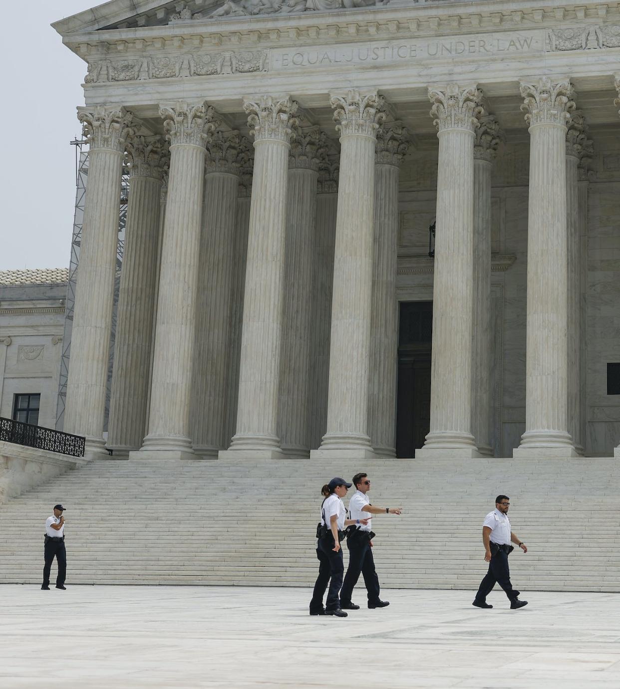 Police officers patrolling the front of the Supreme Court building. <a href="https://www.gettyimages.com/detail/news-photo/police-officers-with-the-u-s-supreme-court-detain-a-man-who-news-photo/1504442811?adppopup=true" rel="nofollow noopener" target="_blank" data-ylk="slk:Anna Moneymaker/Getty Images;elm:context_link;itc:0;sec:content-canvas" class="link ">Anna Moneymaker/Getty Images</a>