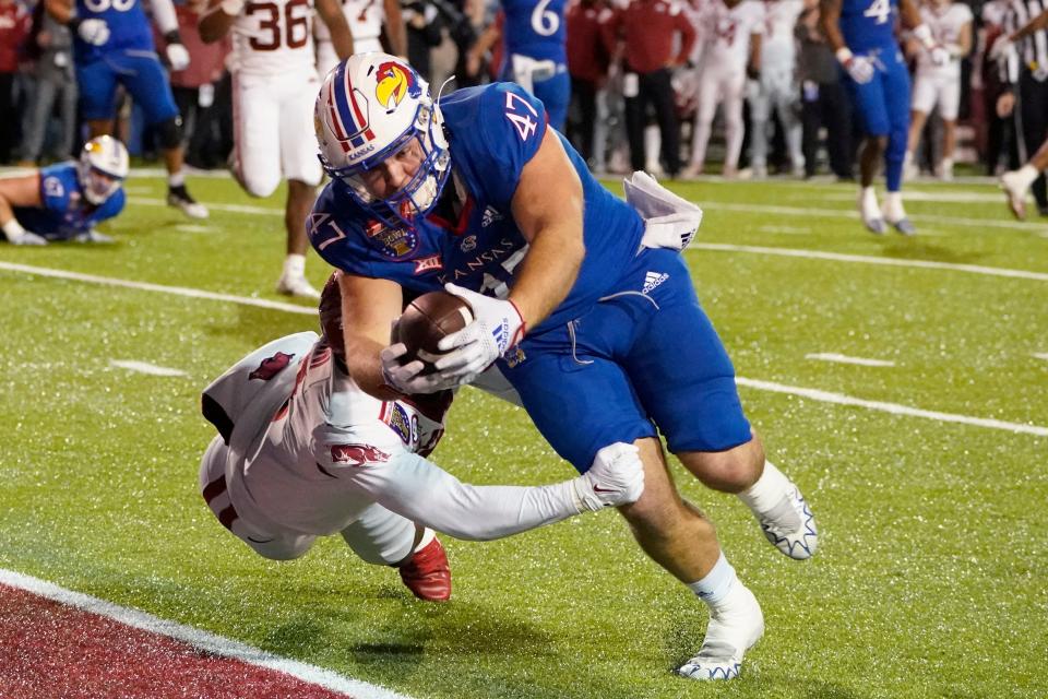 Kansas tight end Jared Casey (47) lunges for a touchdown against Arkansas in overtime during the Liberty Bowl on Wednesday in Memphis. Arkansas won in three overtimes, 55-53.