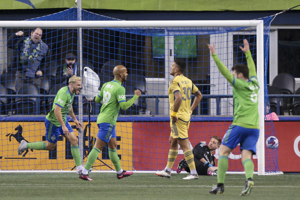 Seattle Sounders forward Jordan Morris, left, celebrates after his goal with forward Heber (19) and midfielder Joao Paulo (6) as Real Salt Lake goalkeeper Zac MacMath, second from right, and defender Marcelo Silva (30) react during the first half of an MLS soccer match Saturday, March 4, 2023, in Seattle. (AP Photo/Jason Redmond)