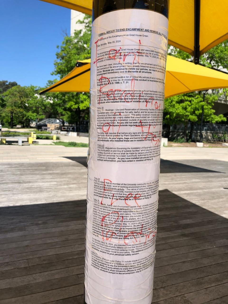 The university has put up its formal notice to end the encampment on lights posts and umbrella stands near the area around where the encampment has been set up.
