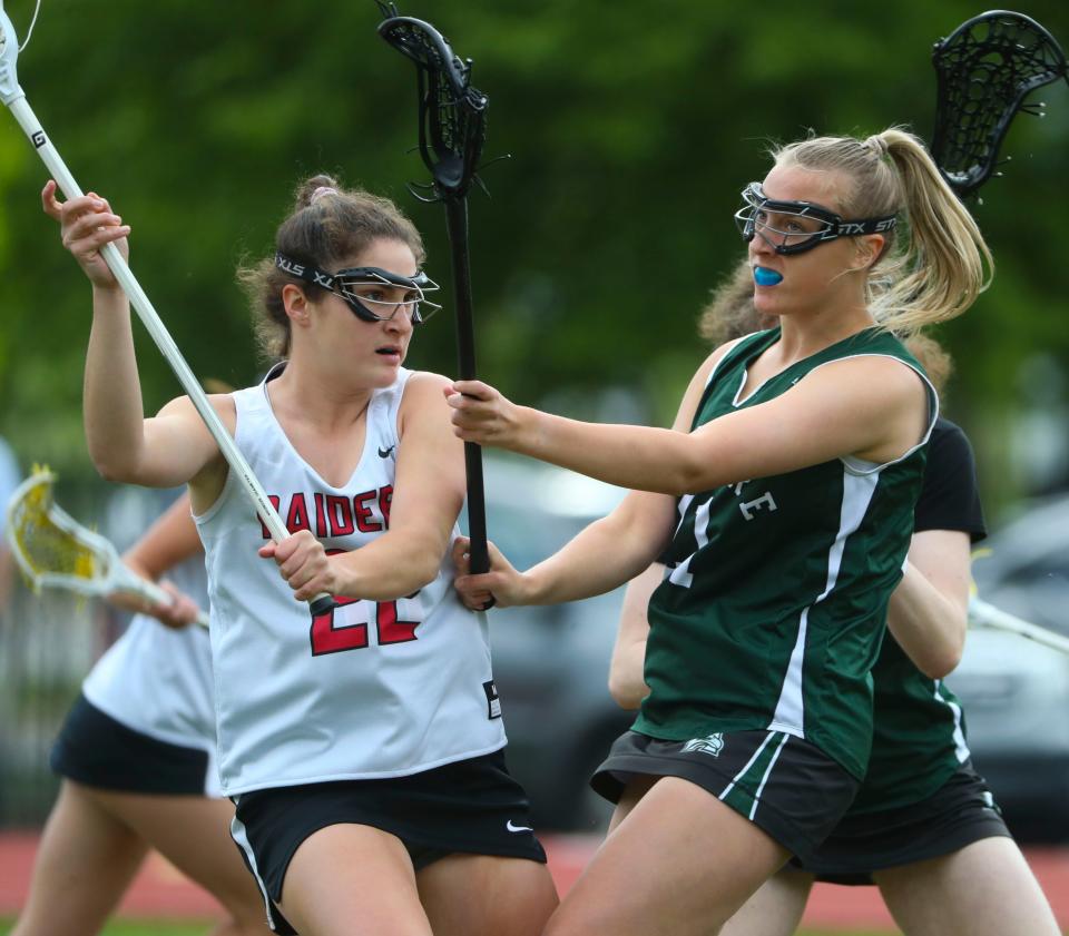 Ursuline's Claire Fowler (left) works against Archmere's Audrey Mahoney in the Auks' 13-11 win in a visit to Serviam Field, Friday, May 5, 2023.