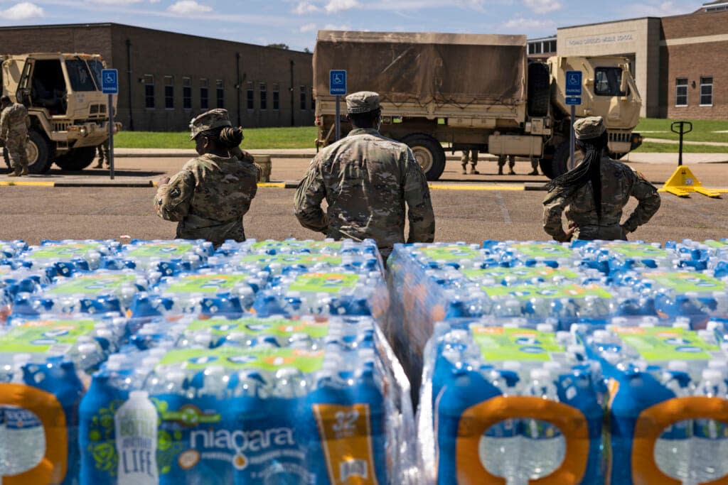 Members of the Mississippi National Guard hand out bottled water at Thomas Cardozo Middle School in response to the water crisis on Sept. 1 in Jackson, Mississippi. Jackson has been experiencing days without reliable water service after river flooding caused its main treatment facility to fail. (Photo: Brad Vest/Getty Images)