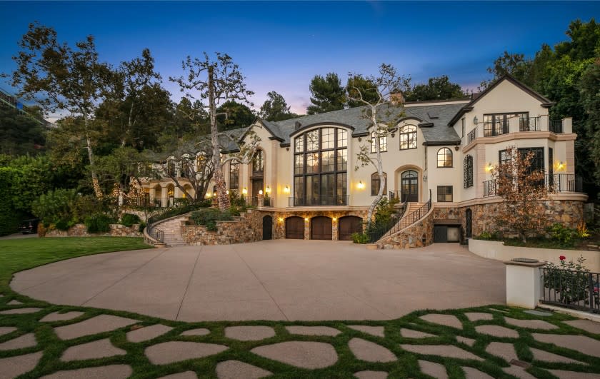 The compound includes a 16,000-square-foot mansion, a tennis court and a swimming pool with a 60-foot slide.