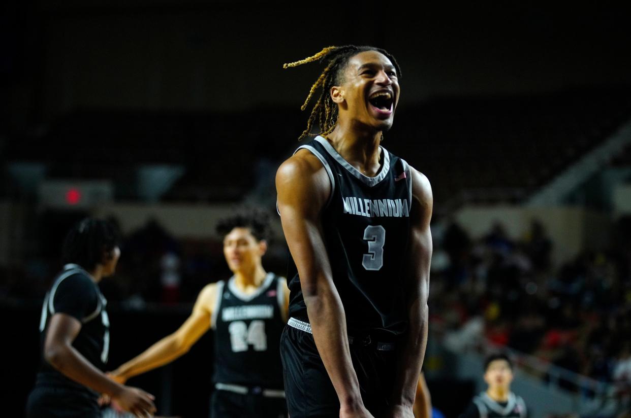 Millennium forward Cameron Holmes (3) celebrates a Sabien Cain three followed by a Perry timeout during the Open State Championship game at Arizona Veterans Memorial Coliseum.