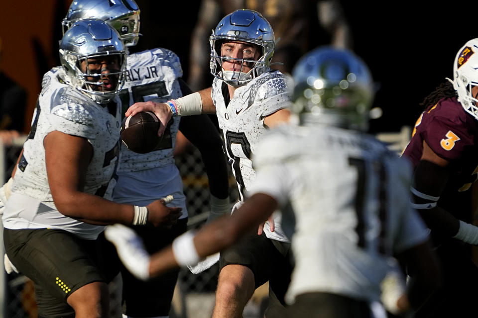 Oregon quarterback Bo Nix, center, looks to pass against Arizona State during the first half on an NCAA college football game, Saturday, Nov. 18, 2023, in Tempe, Ariz. (AP Photo/Matt York)