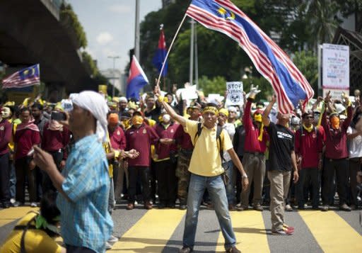 A protestor waves the Malaysian national flag during an anti-government protest in Kuala Lumpur on April 28, 2012. Malaysian clerics have issued a fatwa against demonstrations, days after Prime Minister Najib Razak said a quashed election reform rally was being used to topple the government ahead of polls