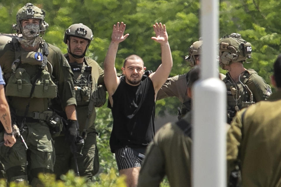 CORRECTS AGE: Almog Meir Jan, 22, kidnapped from Israel in a Hamas-led attack on Oct. 7, 2023, raises his hands after arriving by helicopter to the Sheba Medical Center in Ramat Gan, Israel, Saturday, June 8, 2024. Israel says it has rescued four hostages in Gaza who were kidnapped in a Hamas-led attack on Oct. 7. (AP Photo/Tomer Appelbaum)