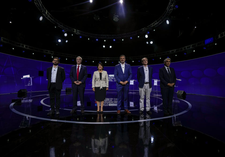 Chilean presidential candidates, from left, Gabriel Boric from the Apruebo Dignidad coalition party, Jose Antonio Kast from the Partido Republicano, Yasna Provoste from the Unidad Constituyente party, Sebastián Sichel of the center-right government coalition, Eduardo Artes of the Partido Comunista-Acción Proletaria y Unión Patriótica, and Marco Henriquez-Ominami from the left-wing Progressive Party, pose for a photo prior to the presidential debate in Santiago, Chile, Monday, Nov. 15, 2021. Chile will hold its presidential election on Nov. 21. (AP Photo/Esteban Felix, Pool)