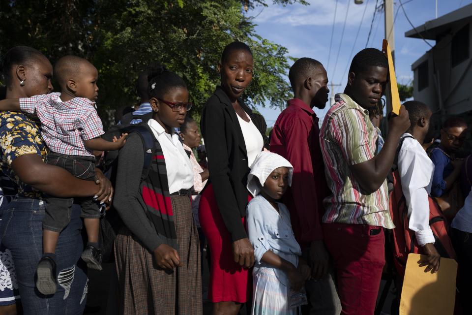 People line up outside of the passport office in Port-au-Prince, Haiti, Thursday, June 1, 2023. (AP Photo/Ariana Cubillos)