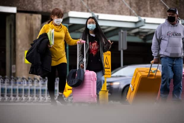 Travellers are pictured outside International arrivals at Vancouver International Airport in Richmond, British Columbia on Thursday, Dec. 31, 2020.  (Ben Nelms/CBC - image credit)