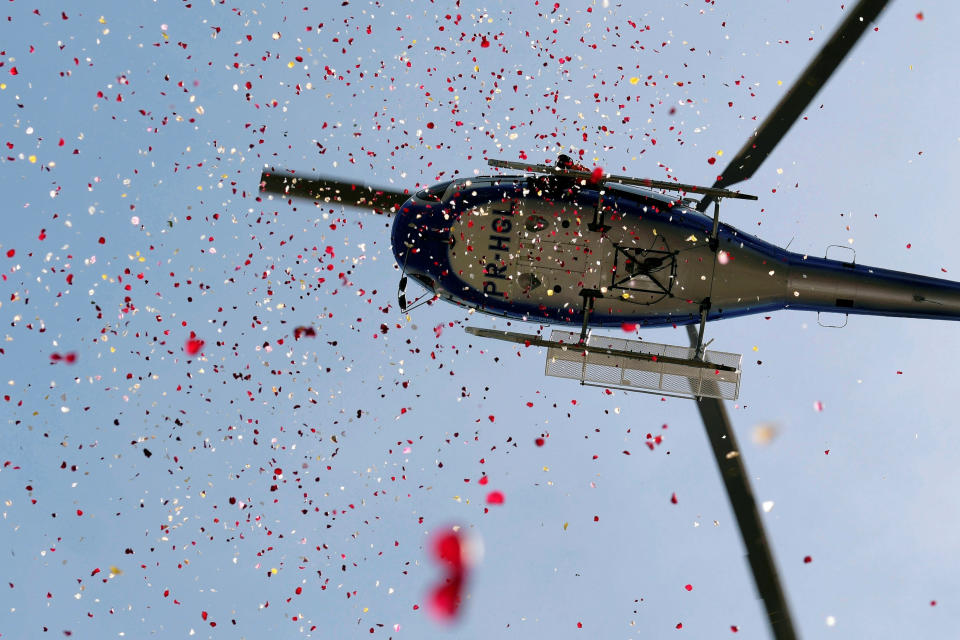A helicopter showers flowers in honor of victims of the collapse of a dam owned by Brazilian mining company Vale SA, in Brumadinho, Brazil February 25, 2019.&nbsp;