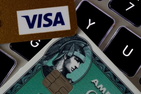 American Express and Visa credit cards are seen on a computer keyboard in this picture illustration