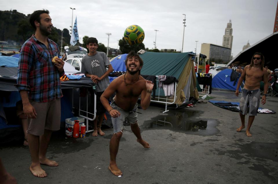 Argentinian fans play with a ball at a tent and motorhome park amongst others waiting out for Sunday's World Cup final between Argentina and Germany at the Terreirao do Samba in Rio de Janeiro