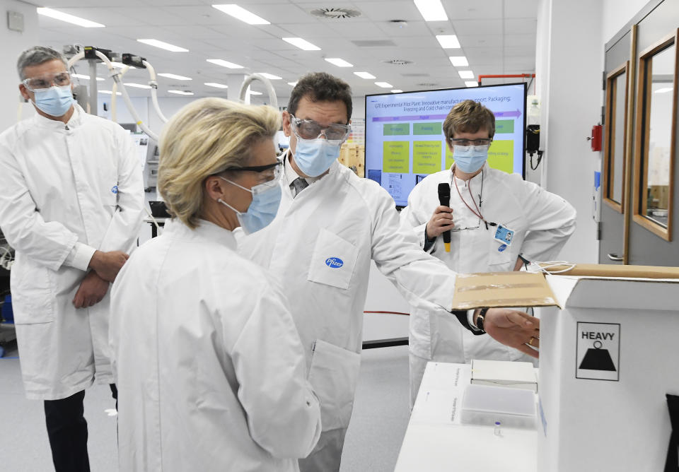 European Commission President Ursula von der Leyen, second left, speaks with Pfizer CEO Albert Bourla, center right, during an official visit to the Pfizer pharmaceutical company in Puurs, Belgium, Friday, April 23, 2021. (John Thys, Pool via AP)